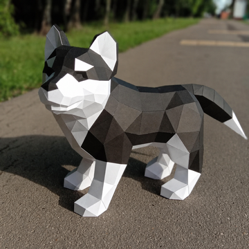 Grote zwart-witte Husky puppy als geometrisch 3D-papiermodel van opzij