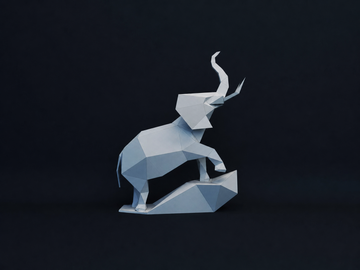 Volledig zijaanzicht van grijze olifant op rots als 3D papiermodel met geheven slurf