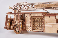 De WoodTrick Rescue Brandweerwagen - Houten Brandweerauto Bouwpakket is een gedetailleerd houten model met "FIRE DEPT" en "CAUTION" labels, gemonteerde ladder, tandwielen en ingewikkelde uitsparingen uit de WoodTrick RESCUE SERIES.