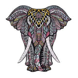 Levendige illustratie van de Grijze Olifant Houten Puzzel (A3 formaat) - Majestueus Dier Figuurpuzzel van SlimSpul nederland b.v., met roze, gele, blauwe en zwarte geometrische ontwerpen over het hoofd van de olifant.