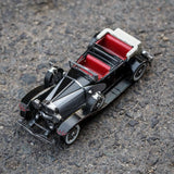 Het 1935 Duesenberg Metalen Bouwpakket - Klassieke Oldtimer Auto van SlimSpul nederland b.v. toont een elegante vintage zwarte cabriolet met rode stoelen en witte accenten, perfect weergegeven op een asfalt oppervlak.